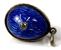 Front view showing blue textured surface and diamond accent