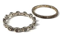 Two sterling silver rings: eternity ring with stones and ridged band