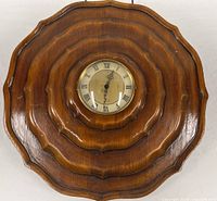 Full front view of scalloped wooden wall clock