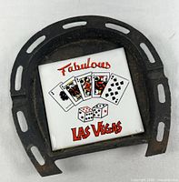 Front view of horseshoe coaster showing tile graphics