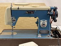 Full left-side view of Montgomery Ward Signature sewing machine on wood base