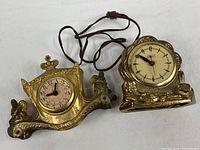 Both mantel clocks side by side showing overall condition and power cord presence