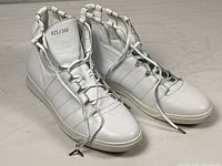 Front and side view of both sneakers showing overall design, lacing system, numbering on tongue