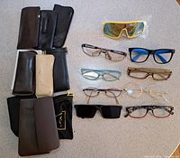 Full lot overview showing eight eyeglasses/sunglasses and nine cases