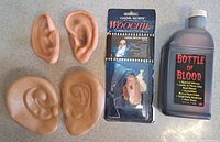 Overall lot with two ear pairs, packaged witch nose, full pint bottle of fake blood