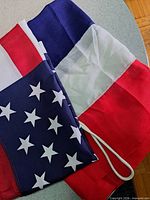 Folded USA and Thailand flags showing colors and hoist rope