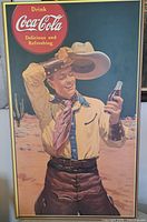 Full view of plaque-mounted Coca-Cola cowboy poster