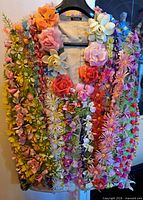 Front view of flower-covered jacket on hanger