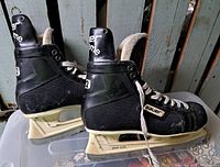 Side view of both Bauer Supreme 92 skates showing holders and overall condition