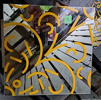 Single mirror tile showing yellow motif and size proportion