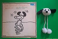 Front sleeve of Snoopy’s Christmas LP and crochet Snoopy cover on green background