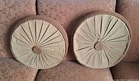 Front view of both round cushions showing pleated design and color