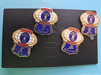 All four enamel pins mounted on card showing designs and sports labels