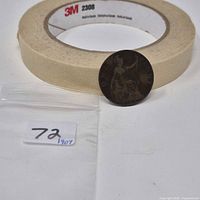 1907 one penny coin front and back shown beside tape roll for scale