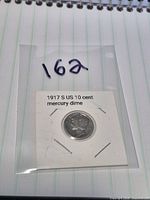 Coin in cardboard flip inside plastic sleeve on notebook background