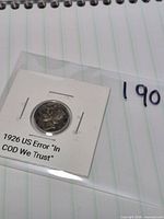 Coin in cardboard flip showing front label and obverse