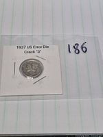 Obverse of 1937 Mercury dime in cardboard flip labelled 1937 US Error Die Crack “3”