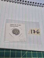 Obverse of 1939-D Mercury dime in labelled 2x2 flip next to lot number tag