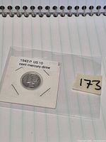 Obverse side of 1943 Mercury dime in labelled flip with lot tag visible