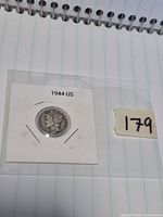 Obverse view of 1944 Mercury dime in labelled cardboard flip