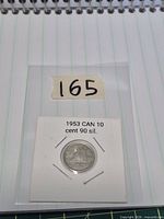 Coin in labeled cardboard flip, full holder view