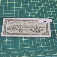 Reverse of 1954 $20 Bank of Canada note in sleeve on cutting mat