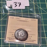 Coin in ICCS holder with lot tag visible