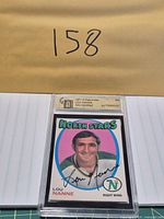 Front view of slabbed Lou Nanne card showing player image and facsimile signature