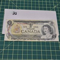 Obverse of 1973 Canada $1 note with Queen Elizabeth II portrait and serial AMZ0122650 showing wear