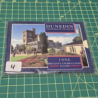 Front of blue presentation folder showing Larnach Castle image and coin details