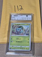 Front view of NXR-slabbed Bulbasaur card showing grade label and card artwork