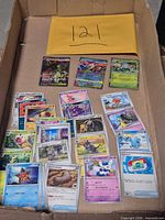 All cards in cardboard box with envelope showing lot number
