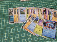 Fanned spread of Korean Pokémon TCG cards on cutting mat, showing Feraligatr holo and multiple other cards