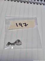 Charm in sealed bag with lot number showing overall size and components