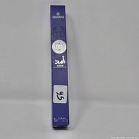 Side view of purple Rissers Asad Eau de Parfum box showing branding and Arabic script