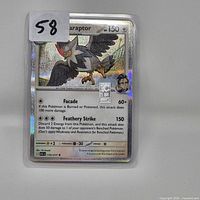 Front view of Staraptor card showing silver bar modification and holographic surface in clear holder