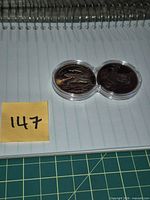Overview of both copper rounds in joined capsule on notebook