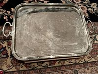 Full view of rectangular metal tray showing surface and handles