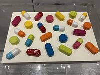 Oblique top view showing coloured pill forms on base