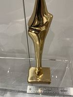full view of bronze abstract sculpture on base
