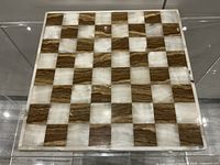 Top view of marble chessboard face showing 8x8 squares