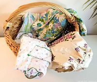 Basket holding assorted floral aprons