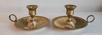 Two brass enamel chamberstick holders side by side front view