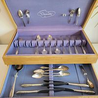 Open chest showing Community flatware arrangement