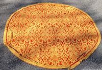 Full view of round damask throw showing pattern and shape