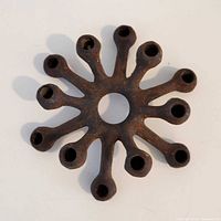 top view showing 12-arm spider design and rust patina