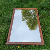 Full view of rectangular mirror with wood frame