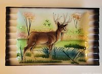 front view showing stag scene and stepped cigar rests