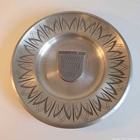 Front view showing etched border and crest