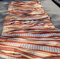 Both drapery panels laid flat to show overall length and pattern
